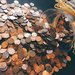 Stock Image - Coins spilling from jar